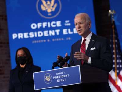 President-elect Joe Biden speaks as Vice President-elect Kamala Harris looks on during day two of laying out his plan on combating the coronavirus at the Queen theater January 15, 2021, in Wilmington, Delaware.