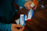 Susan Stevens shows off a prescription for Suboxone at her home in Lewisville, North Carolina, on March 11, 2019.