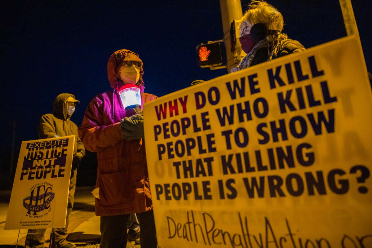 Bloomington anti-death-penalty activist Glenda Breeden holds a lamp while protesting against the execution of Lisa Montgomery and two others, in Bloomington, Indiana, on January 12, 2021.