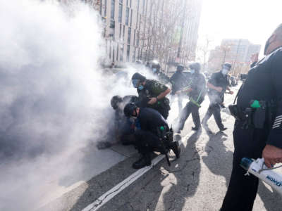 Police intervene as Trump supporters and counter protesters fight during a protest in Los Angeles, California, on January 6, 2021.