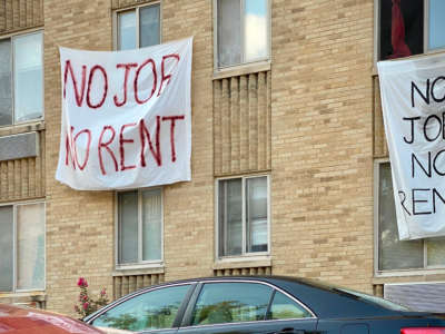 Banners reading "no job no rent" are displayed on a building in Washington, D.C., on August 9, 2020.