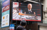 A man is seen watching the news report of the inauguration of U.S. President Joe Biden on a large screen in Hong Kong, China. on January 21, 2021.