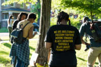 Participants take part in an event organized by Love & Protect to lift up the names and celebrate the lives of Black women and girls who have been killed by state violence at Rekia's Tree in Douglass Park, Chicago, on June 13, 2018.