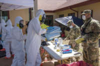 Colorado National Guard members of the Chemical, Biological, Radiological, Nuclear and high-yield (CBRNE) Enhanced Response Force Package (CERFP) team member, processes through the decontamination station after performing COVID-19 testing at a state veterans home in Aurora, Colorado, April 29, 2020.