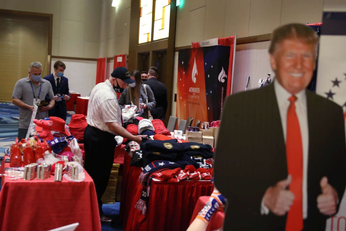 People browse items for sale supporting former President Donald Trump's that are on display at the Conservative Political Action Conference held in the Hyatt Regency on February 27, 2021, in Orlando, Florida.