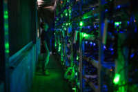 A bitcoin mine site manager checks mining equipment inside a bitcoin mine near Kongyuxiang, Sichuan, China.