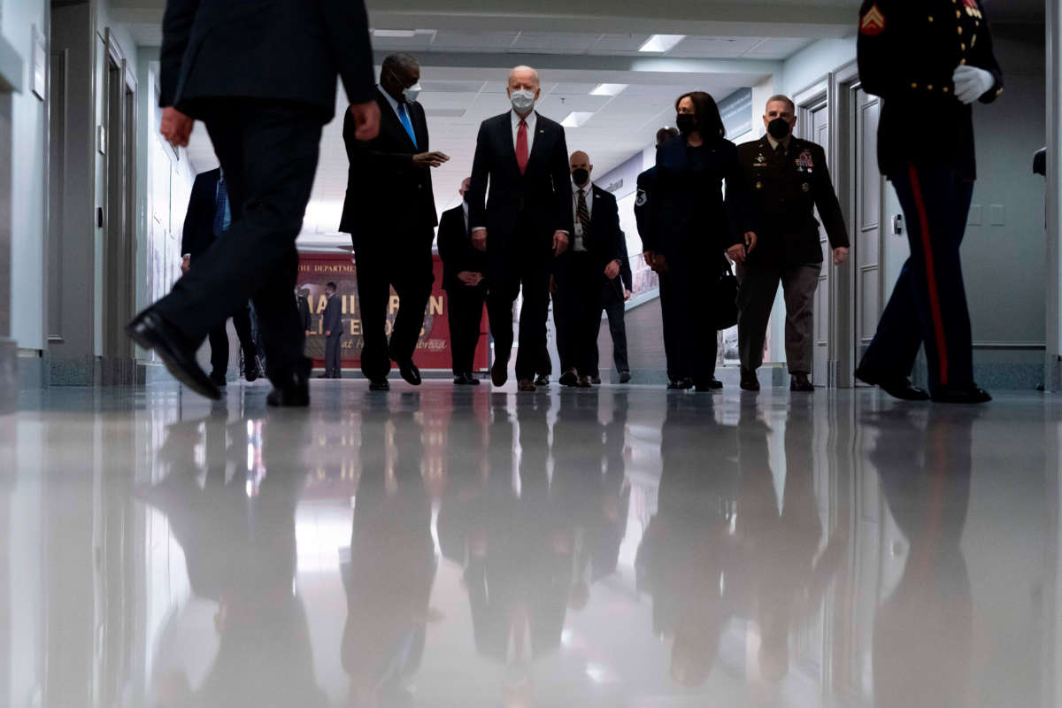 President Joe Biden, center, accompanied by Vice President Kamala Harris, right center, Secretary of Defense Lloyd Austin, left, and Joint Chiefs Chairman Gen. Mark Milley, right, tours the Pentagon on February 10, 2021, in Washington, D.C.