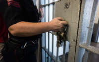 A prison guard opens a locked door with keys inside Angola prison on October 14, 2013.