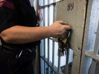 A prison guard opens a locked door with keys inside Angola prison on October 14, 2013.