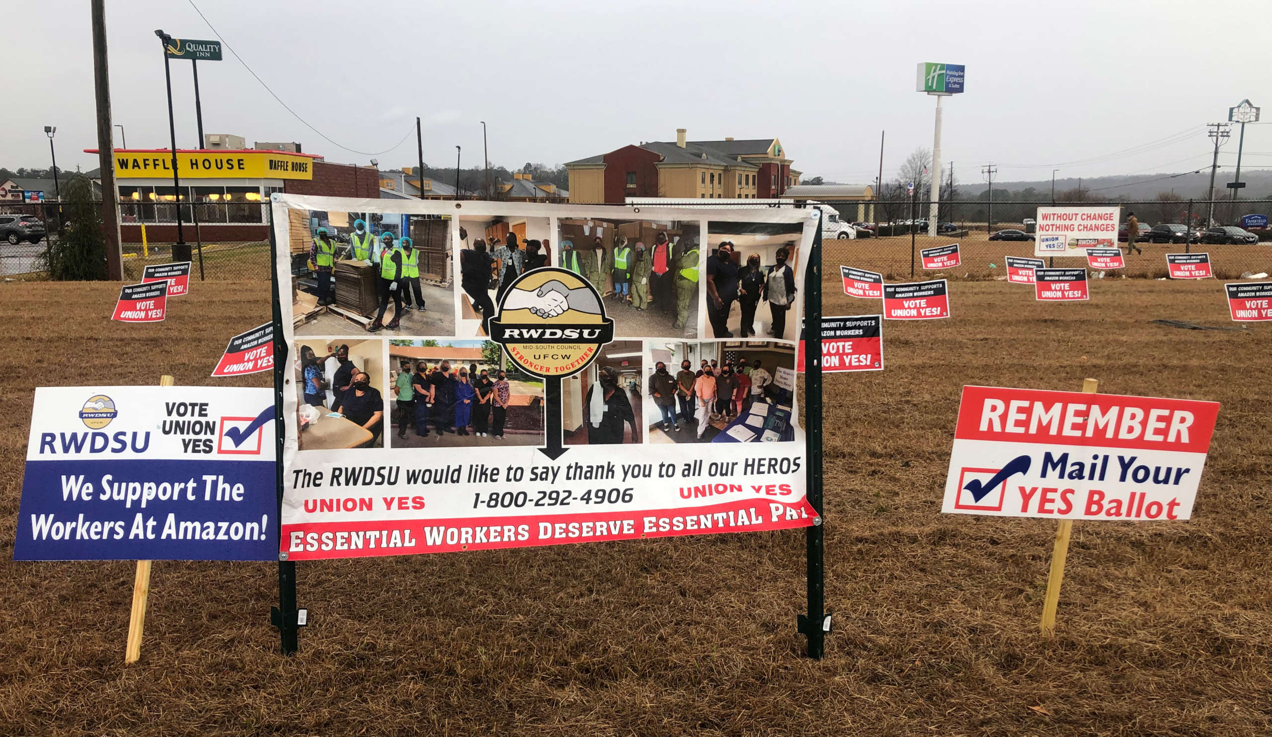 Yard signs with voting yes messages plucked into a field before the start of a union rally in Bessemer, Alabama on February 6, 2021. 
