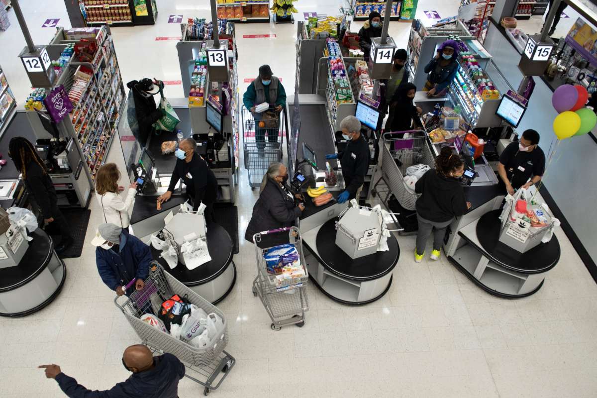 People shop after U.S. Vice President Kamala Harris visited a pharmacy administering Covid-19 vaccines in a Giant Food grocery store February 25, 2021, in Washington, D.C.