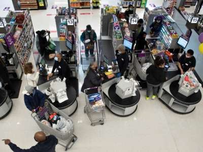 People shop after U.S. Vice President Kamala Harris visited a pharmacy administering Covid-19 vaccines in a Giant Food grocery store February 25, 2021, in Washington, D.C.
