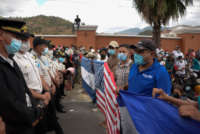 Honduran migrants, part of a caravan heading to the United States, stand in front of a police cordon, in Vado Hondo, Guatemala, on January 17, 2021.