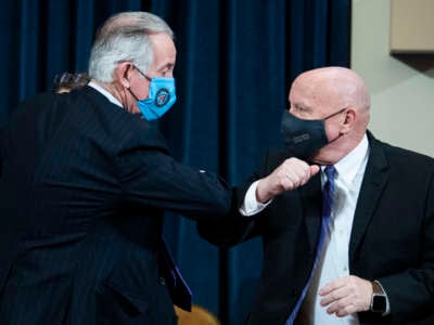 House Ways and Means Chairman Richard Neal, a Democrat, and ranking member Rep. Kevin Brady, a Republican, bump arms in the Longworth Building on February 10, 2021.