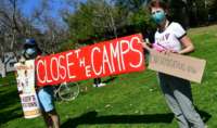 Activists gather for a "Reunite Our Families Now" rally in Los Angeles, California, on March 6, 2021, to protest continued deportations under President Joe Biden, urging that ICE (Immigration and Customs Enforcement) be abolished and calling for the closure of camps where immigrants are being held.