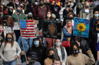 A crowd of local protesters and members of Until Freedom lead a march from Jefferson Square Park on March 13, 2021, in Louisville, Kentucky.