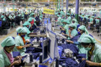 Garment employees work in a sewing section of a Textile Mills Limited in Gazipur, Bangladesh, on March 18, 2021.