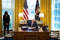 President Joe Biden participates in a bill signing as Vice President Kamala Harris looks on in the Oval Office of the White House on March 11, 2021, in Washington, D.C.