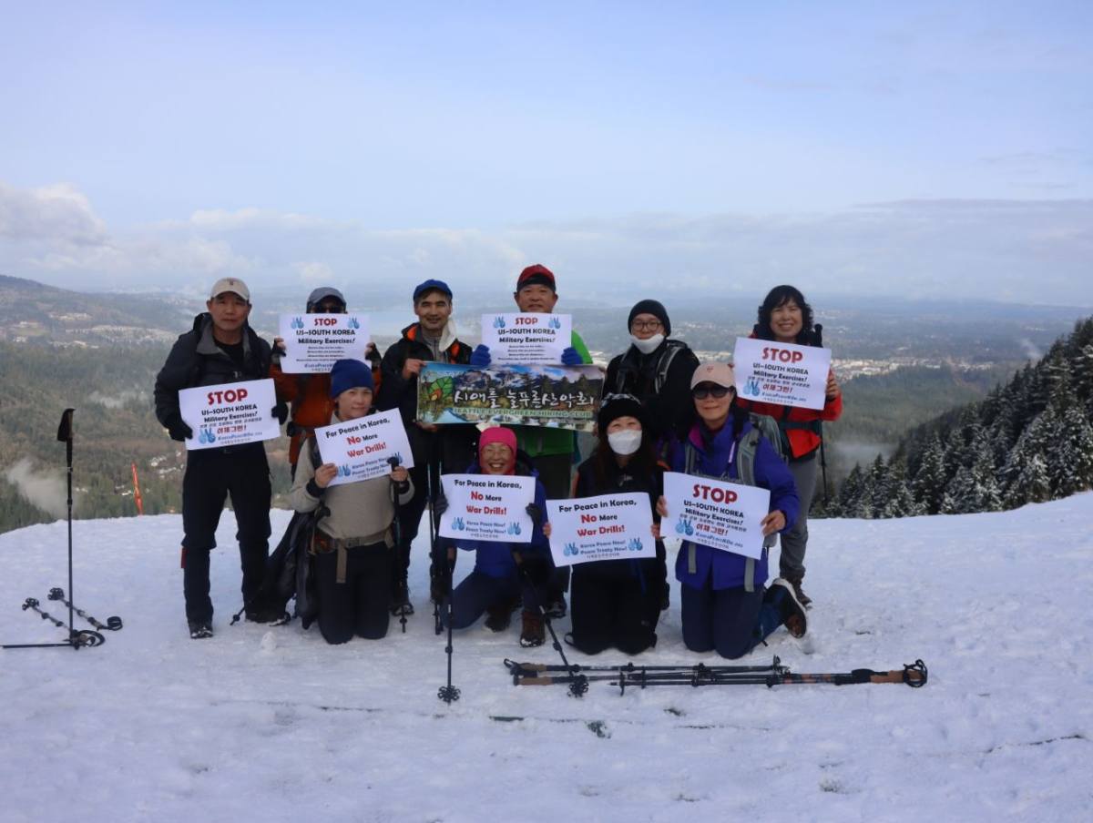 Activists display anti-military exercise signs in the snow