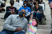Dontaye Carter and daughter Kyleigh Carter look around the capitol building as demonstrators hold a sit-in inside of the capitol building in opposition of House Bill 531 on March 8, 2021, in Atlanta, Georgia.