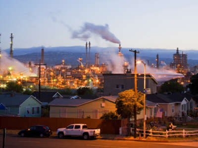 Residential houses next to an oil refinery in the Wilmington neighborhood of Los Angeles, California.