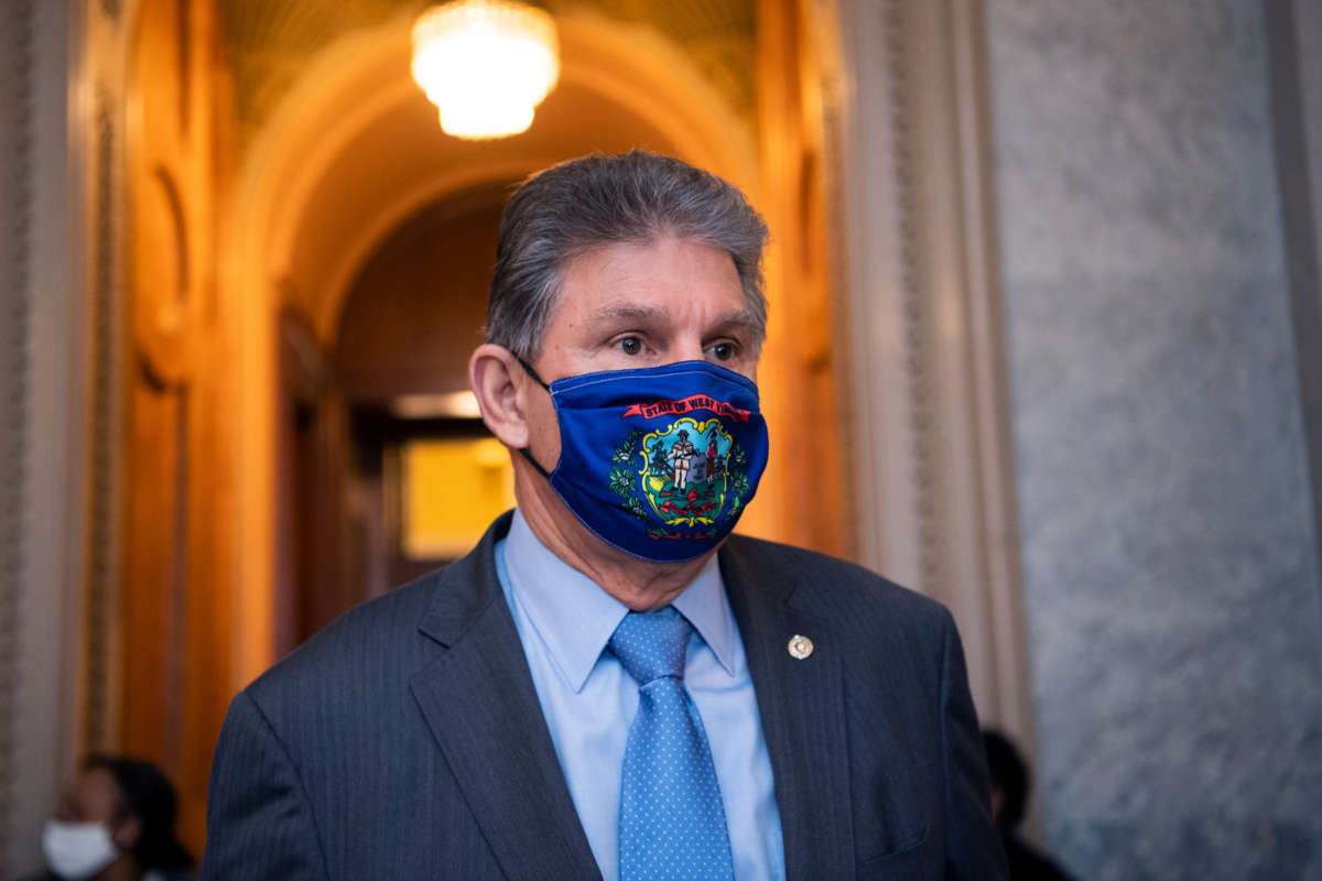 Joseph Manchin, whose name desperately needs to be a verb by this point, walks down a hallway or something