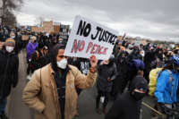 Demonstrators protesting the shooting death of Daunte Wright march to the FBI offices from the Brooklyn Center police station on April 13, 2021 in Brooklyn Center, Minnesota.