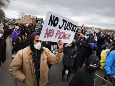 Demonstrators protesting the shooting death of Daunte Wright march to the FBI offices from the Brooklyn Center police station on April 13, 2021 in Brooklyn Center, Minnesota.