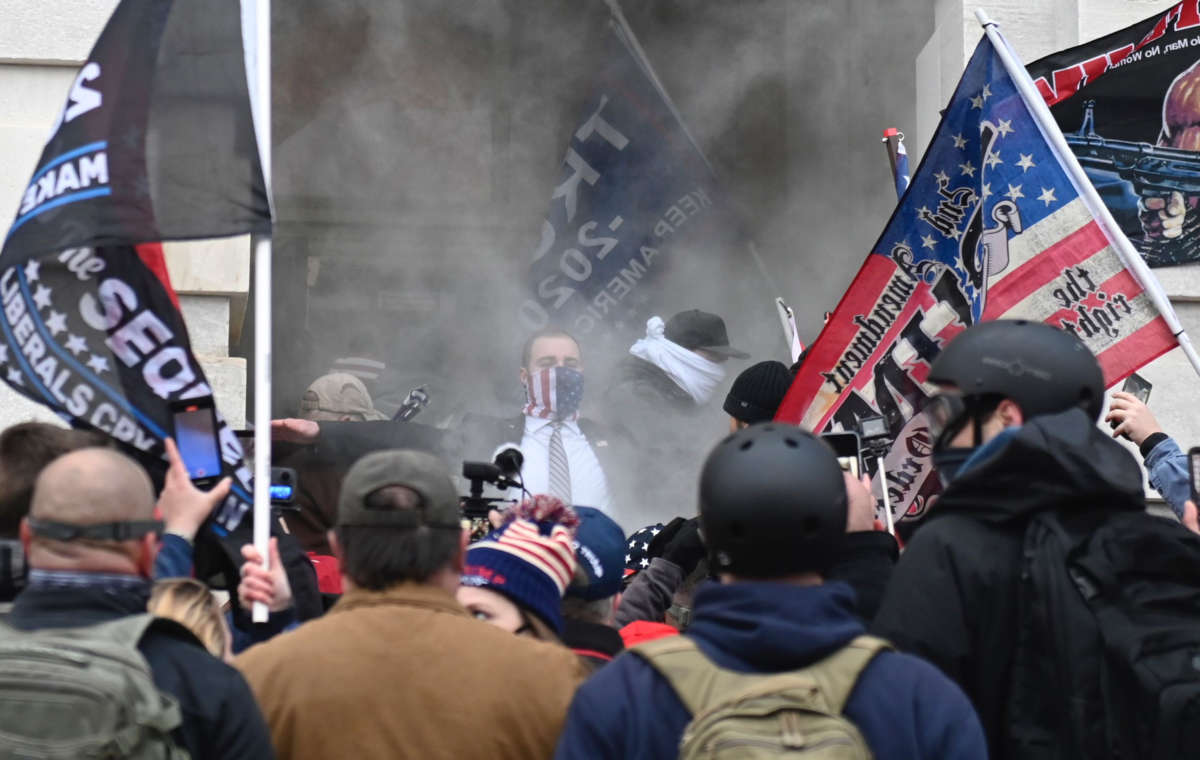 Trump supporters are seen through tear gas outside the U.S. Capitol in Washington, D.C., on January 6, 2021.