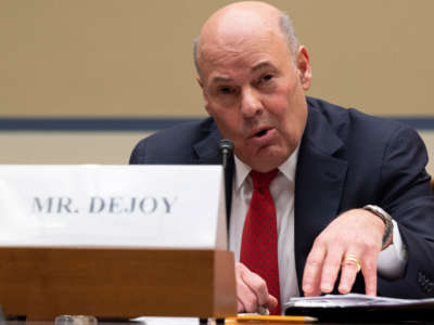 USPS Postmaster General Louis DeJoy testifies during a House Oversight and Reform Committee hearing on USPS Financial Sustainability on February 24, 2021, on Capitol Hill in Washington, D.C.
