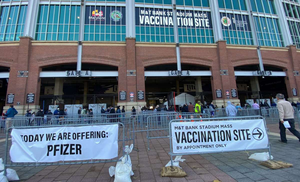 People line up at M&T Bank Stadium in Baltimore, Maryland, which was transformed into a COVID-19 mass vaccination site, on March 20, 2021.