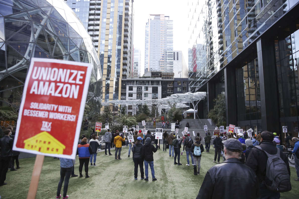 People hold pro-union signs during a rally at the Amazon Spheres and headquarters in solidarity with Amazon workers hoping to unionize in Bessemer, Alabama, in Seattle, Washington, on March 26, 2021.