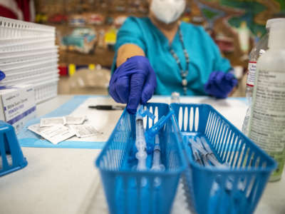 A nurse fills up a syringe with the Moderna COVID-19 vaccine at a vaccination site at a senior center on March 29, 2021, in San Antonio, Texas.