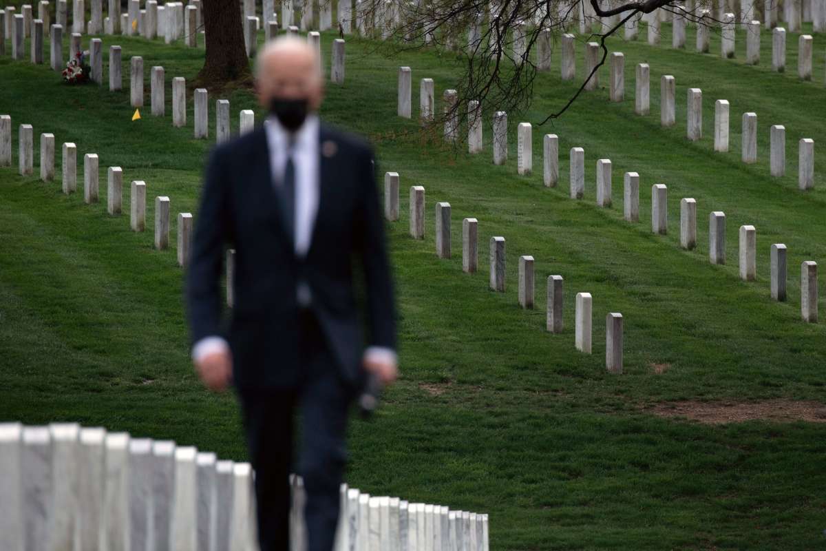 President Joseph Robinette Biden walks away from the corpses of the fallen