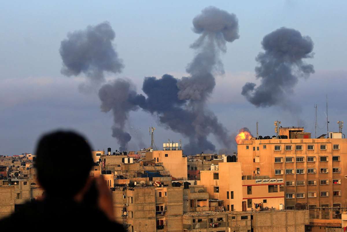 Smoke billows from homes bombed by Israeli forces