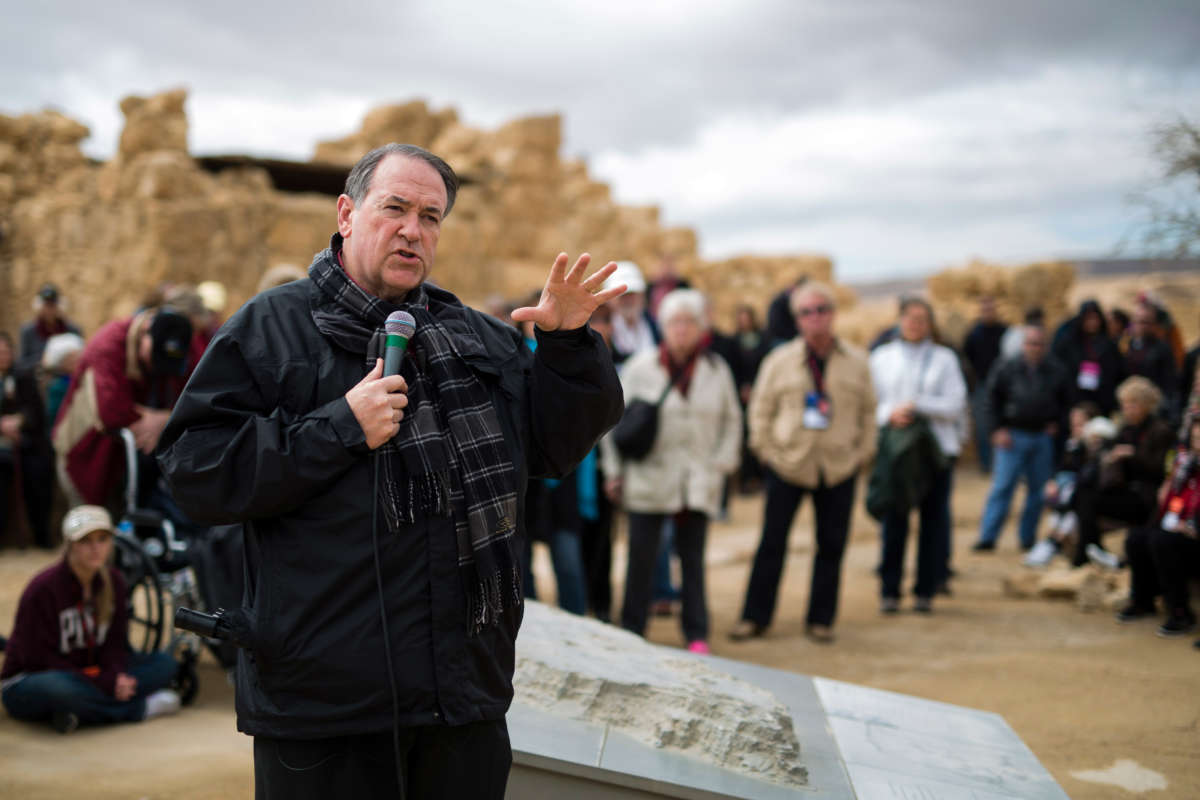 Former Arkansas Gov. Mike Huckabee is seen as he delivers a speech to a group of American Evangelical Christian tourists and pilgrims during a visit to the ancient hilltop fortress of Masada in the Judaean Desert in Israel, on February 19, 2015.