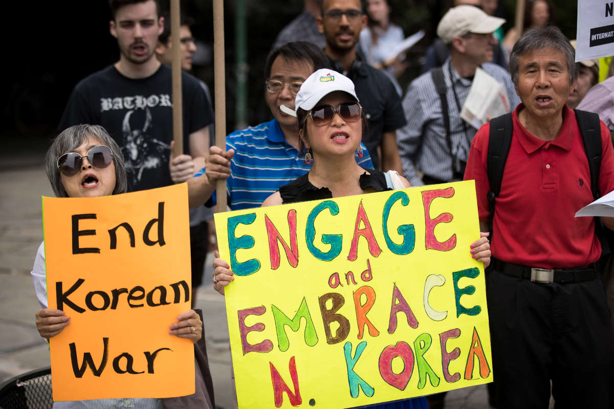 Activists, including several Korean-Americans, rally against possible U.S. military action and sanctions against North Korea, across the street from the United Nations headquarters on August 14, 2017, in New York City.