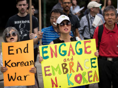 Activists, including several Korean-Americans, rally against possible U.S. military action and sanctions against North Korea, across the street from the United Nations headquarters on August 14, 2017, in New York City.