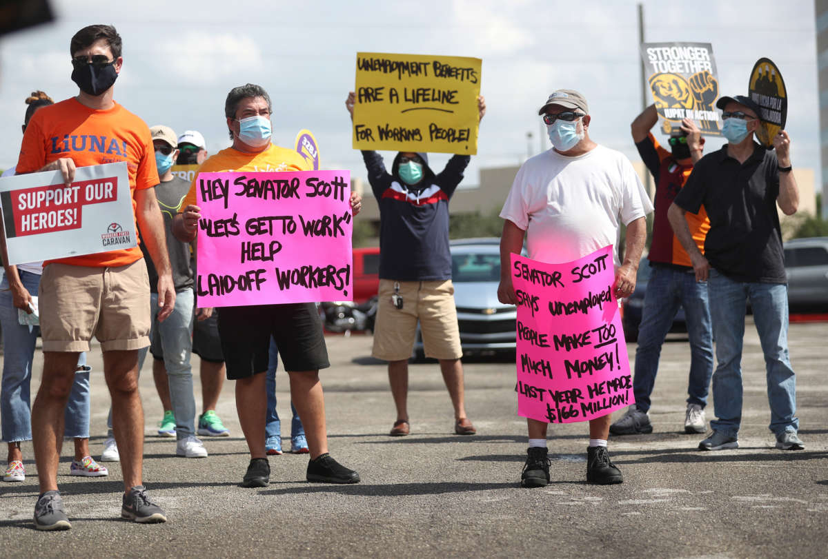 Protesters join together asking senators to support the continuation of unemployment benefits on July 16, 2020, in Miami Springs, Florida.