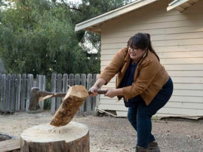 Jana Schmieding chopping wood as Reagan Wells from episode 102 "Buckheart Lodge" of NBC's "Rutherford Falls"