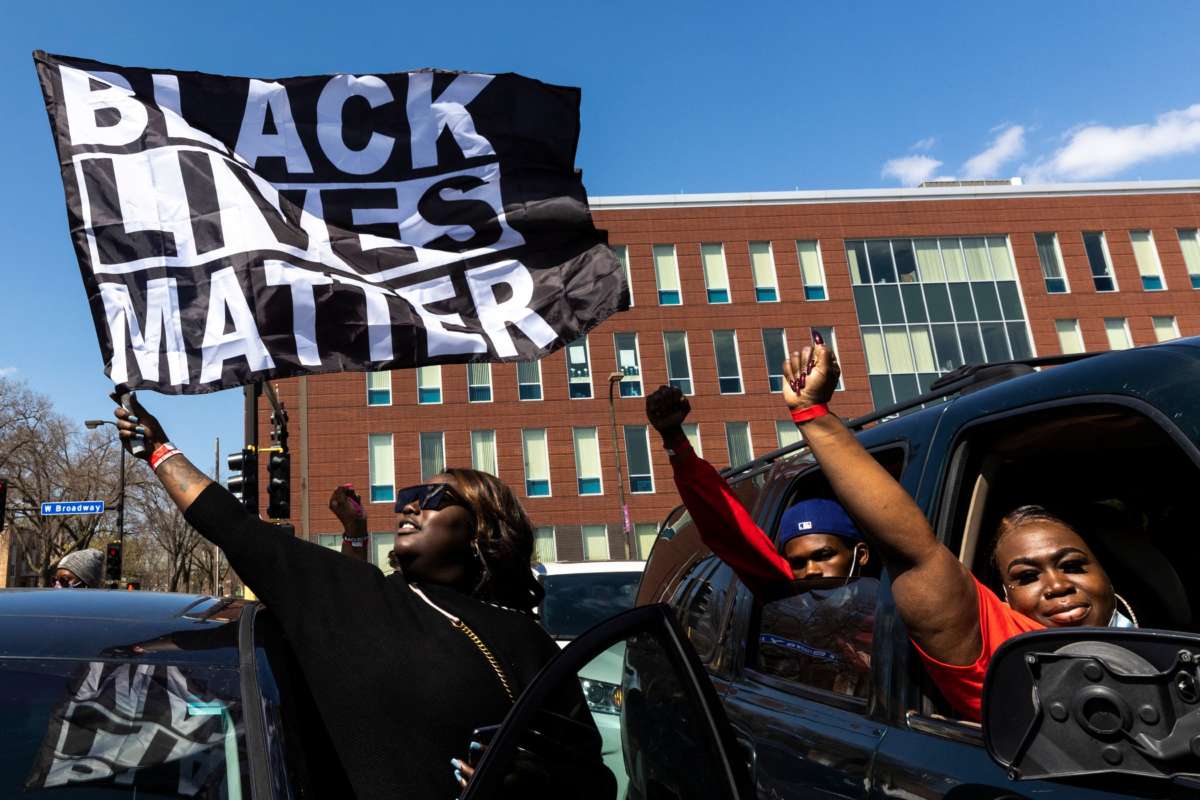 A woman holds a Black Lives Matter flag during the funeral service of Daunte Wright outside the Shiloh Temple International Ministries in Minneapolis, Minnesota, on April 22, 2021.