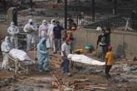 Bodies of victims who died due to the COVID-19 coronavirus are seen before cremation at a cremation ground in New Delhi, India, on May 2, 2021.