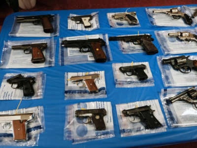 Guns are displayed on a table during a gun buy-back event at a church in Staten Island on April 24, 2021, in New York City.