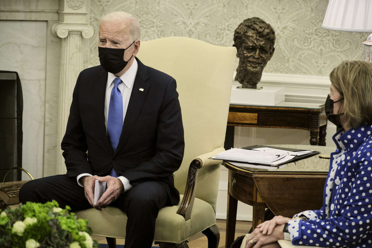 President Joe Biden makes a statement to the press as Sen. Shelley Capito listens during a meeting with a group of Republican senators to discuss the administration’s infrastructure plan in the Oval Office at the White House on May 13, 2021, in Washington, D.C.