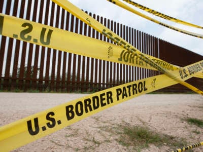 Caution tape from the U.S. Border Patrol marks a road along the levee next to the Border Wall at the international bridge that connects Hidalgo, Texas, and Reynosa, Mexico.