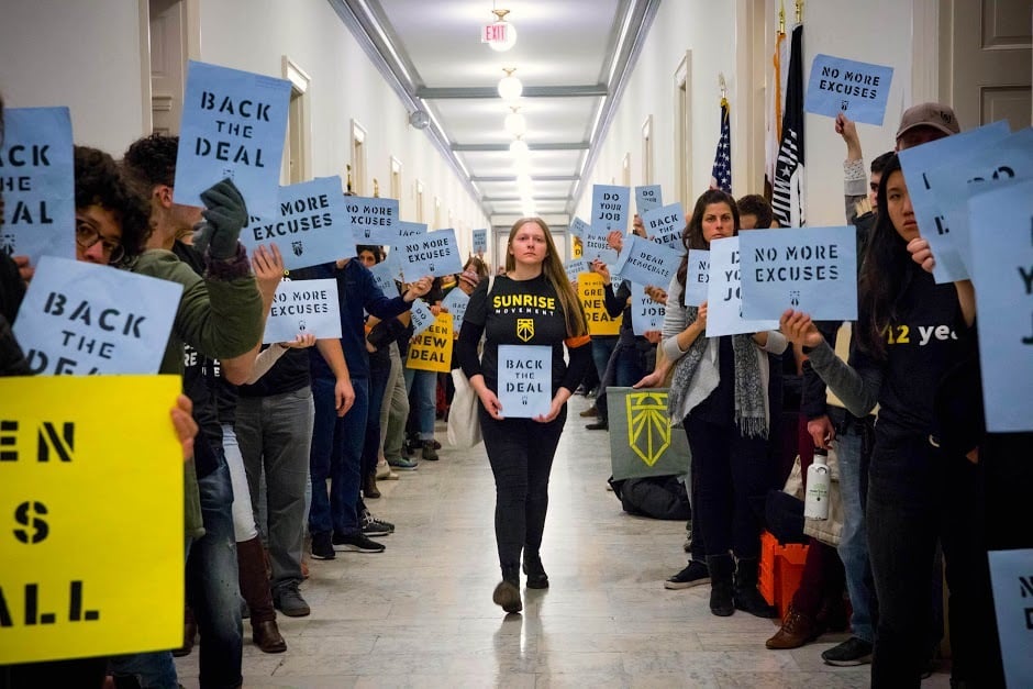 Sunrise Movement activists rally for a Green New Deal in the halls of Congress in 2018.