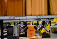 A worker prepares amazon packages in a warehouse