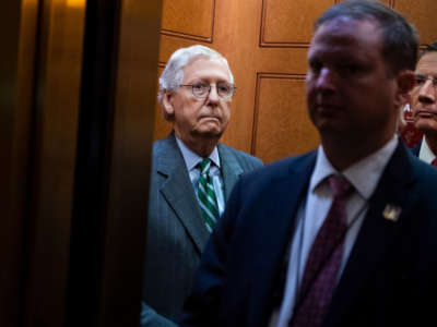 Senate Minority Leader Mitch McConnell, left, and John Barrasso, right, make their way to a news conference in the Capitol on June 17, 2021.