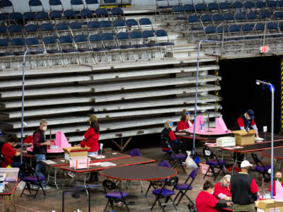 Contractors working for Cyber Ninjas, which was hired by the Arizona State Senate, examine and recount ballots from the 2020 general election at Veterans Memorial Coliseum on May 1, 2021, in Phoenix, Arizona.