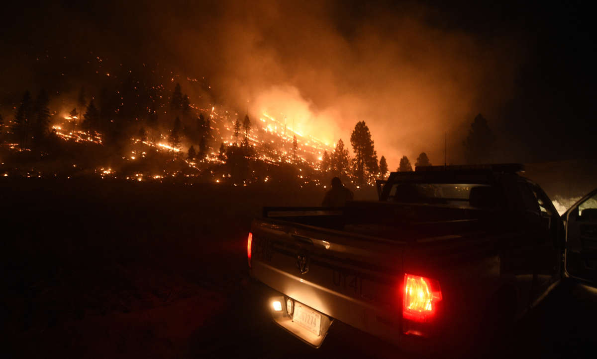 A U.S. Forest Service Public Information Officer surveys the effects of the southeastern flank of the Tennant Fire in California on July 4, 2021.